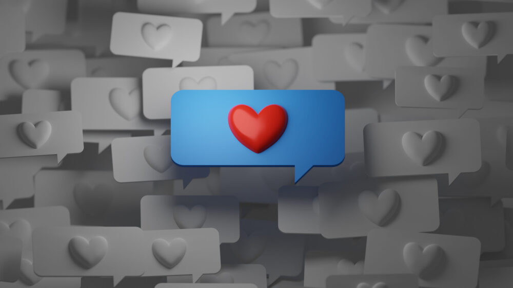 グレーの複数のハートマークの吹き出しの上に青い吹き出しのハートマークが１つある