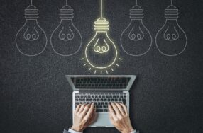 ノートパソコンを操作する上部に５つの電球の１つが光っている